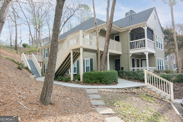 500 Bainbridge Dr, Atlanta, GA 30327 - view of side of home with stairs, a shingled roof, and a chimney