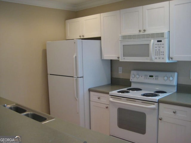kitchen with white appliances, white cabinetry, a sink, and ornamental molding
