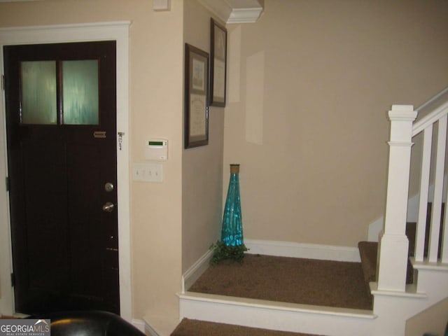 foyer with stairs and baseboards