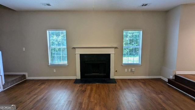 6231 Waterton Way, Lithonia, GA 30058 - unfurnished living room with healthy amount of natural light, wood finished floors, and a fireplace with flush hearth