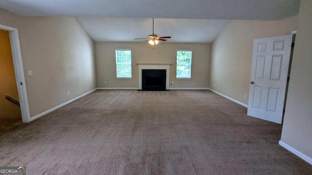 6231 Waterton Way, Lithonia, GA 30058 - unfurnished living room featuring a ceiling fan, carpet floors, a fireplace with flush hearth, and vaulted ceiling