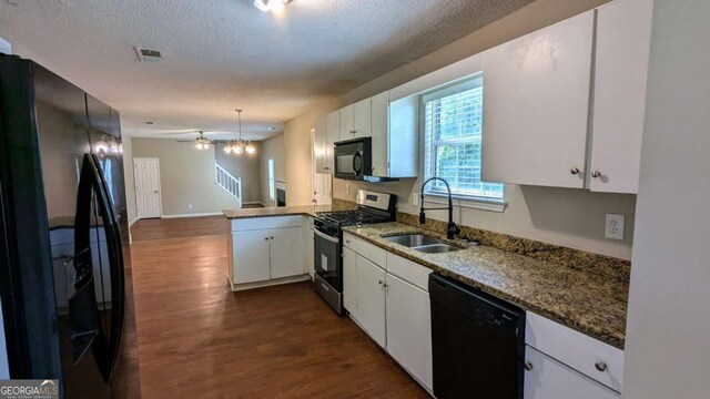 6231 Waterton Way, Lithonia, GA 30058 - kitchen featuring black appliances, dark wood finished floors, white cabinetry, a textured ceiling, and a peninsula