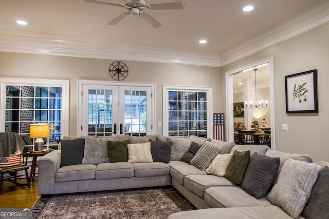living area featuring a chandelier, crown molding, a ceiling fan, recessed lighting, and wood finished floors