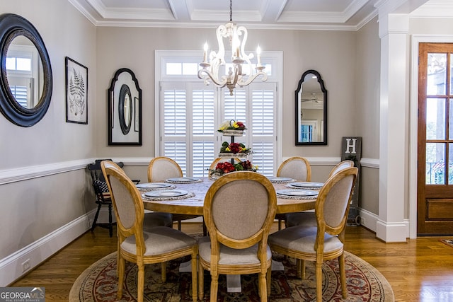 dining room featuring a chandelier, crown molding, wood finished floors, baseboards, and beamed ceiling