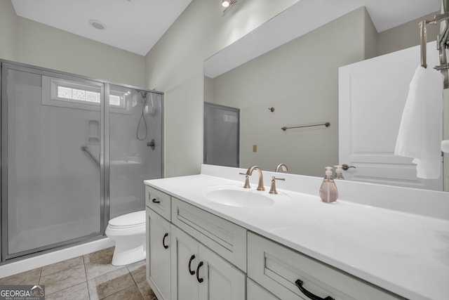 bathroom featuring a shower stall, vanity, and toilet