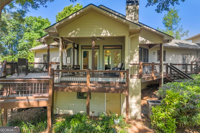 back of property featuring a chimney, central AC, a wooden deck, and a ceiling fan