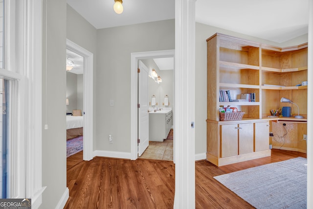 hall with wood finished floors and baseboards