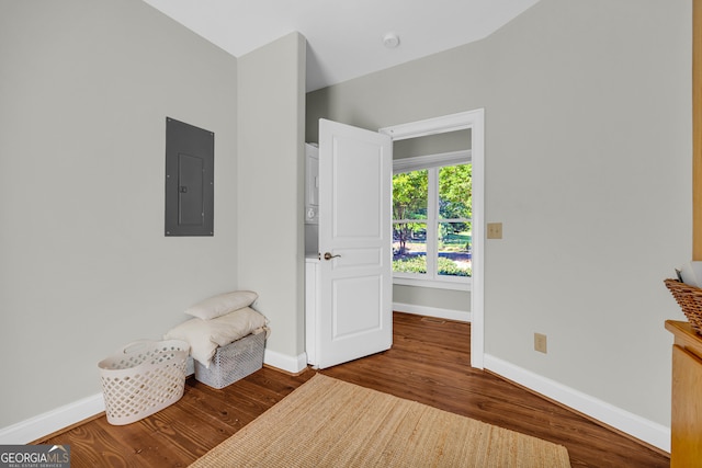 sitting room with electric panel, wood finished floors, and baseboards