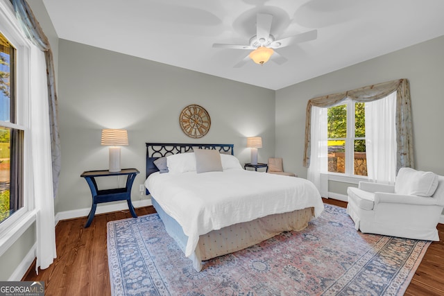 bedroom with wood finished floors, baseboards, and a ceiling fan