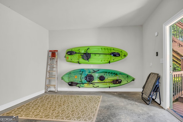 interior space featuring unfinished concrete floors and baseboards