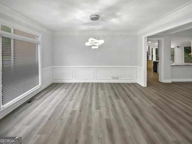 4345 Park Brooke Trce, Johns Creek, GA 30022 - unfurnished dining area with a chandelier, wainscoting, crown molding, and wood finished floors