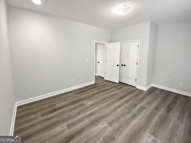 4345 Park Brooke Trce, Johns Creek, GA 30022 - unfurnished bedroom with wood finished floors and a closet