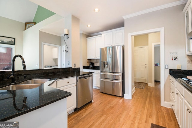 1640 Settindown Dr, Roswell, GA 30075 - kitchen with appliances with stainless steel finishes, a sink, ornamental molding, white cabinets, and dark stone countertops