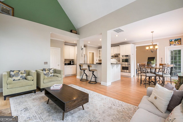 1640 Settindown Dr, Roswell, GA 30075 - living room with a chandelier, light wood-type flooring, vaulted ceiling, crown molding, and recessed lighting