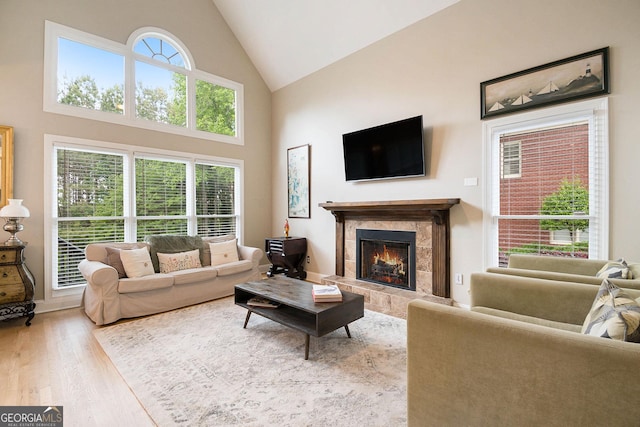 1640 Settindown Dr, Roswell, GA 30075 - living room featuring wood finished floors, a tile fireplace, and high vaulted ceiling