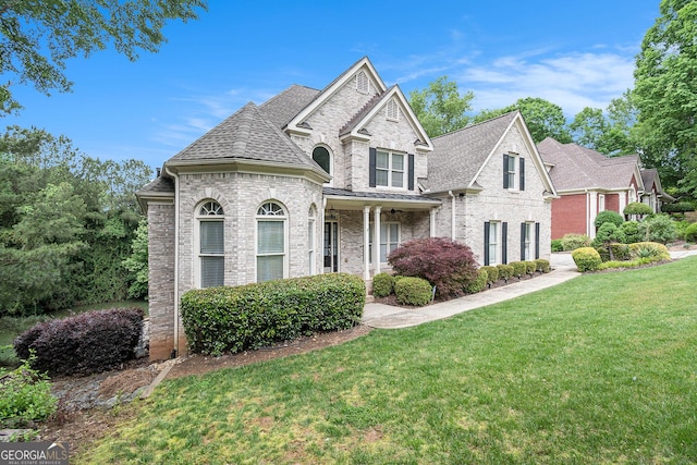 1640 Settindown Dr, Roswell, GA 30075 - view of front of house with brick siding, a front yard, and roof with shingles