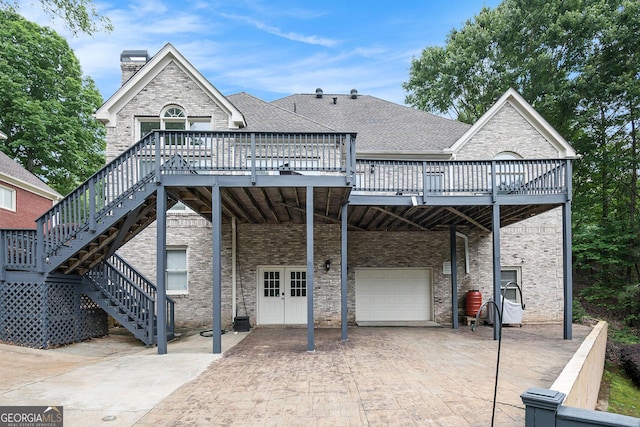 1640 Settindown Dr, Roswell, GA 30075 - view of front facade featuring stairs, an attached garage, a deck, and decorative driveway
