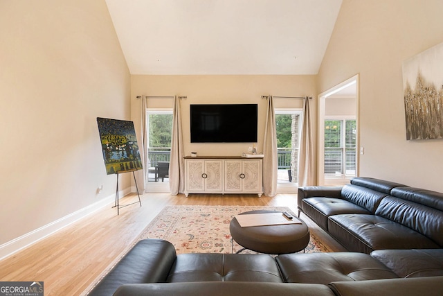 1640 Settindown Dr, Roswell, GA 30075 - living room featuring light wood-style flooring, high vaulted ceiling, and baseboards