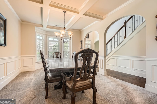 349 Pennant Ln, Fairburn, GA 30213 - carpeted dining space with a chandelier, coffered ceiling, beamed ceiling, a decorative wall, and wainscoting
