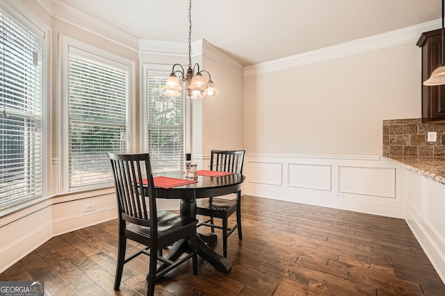 349 Pennant Ln, Fairburn, GA 30213 - dining space with a chandelier, ornamental molding, plenty of natural light, wainscoting, and dark wood finished floors