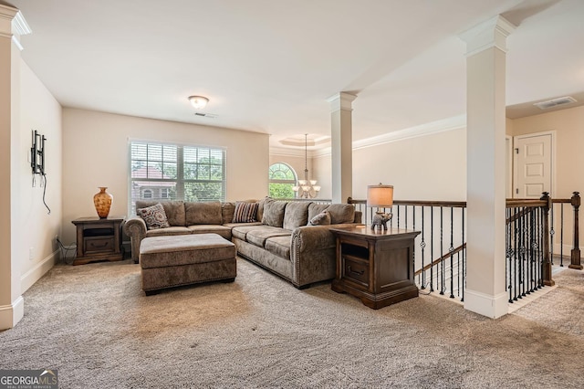 349 Pennant Ln, Fairburn, GA 30213 - carpeted living area with ornate columns, crown molding, a chandelier, and baseboards