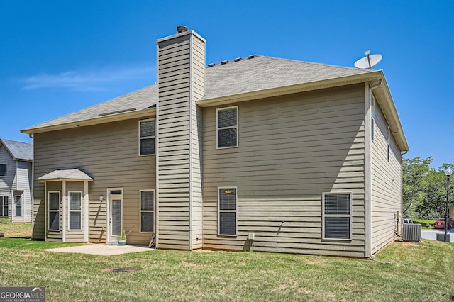 349 Pennant Ln, Fairburn, GA 30213 - rear view of house with central air condition unit, a yard, and a chimney
