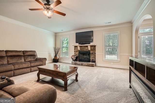 349 Pennant Ln, Fairburn, GA 30213 - carpeted living room with ornamental molding, a ceiling fan, plenty of natural light, and a stone fireplace