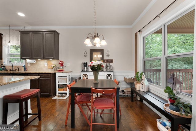 dining room featuring crown molding, a chandelier, dark wood finished floors, and recessed lighting