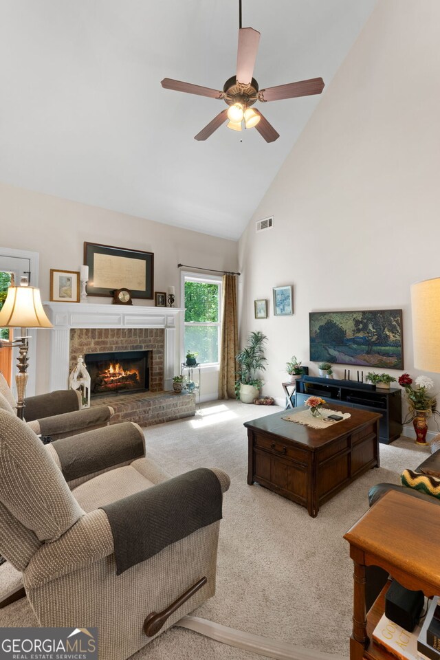 living area featuring carpet floors, high vaulted ceiling, a ceiling fan, and a fireplace