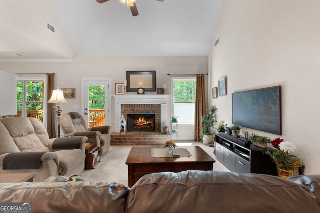 carpeted living room featuring ceiling fan, high vaulted ceiling, and a brick fireplace