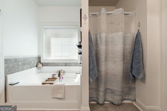 full bathroom featuring a garden tub, a shower with curtain, and tile patterned floors