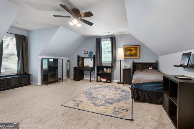 bedroom with carpet flooring, vaulted ceiling, a ceiling fan, and baseboards