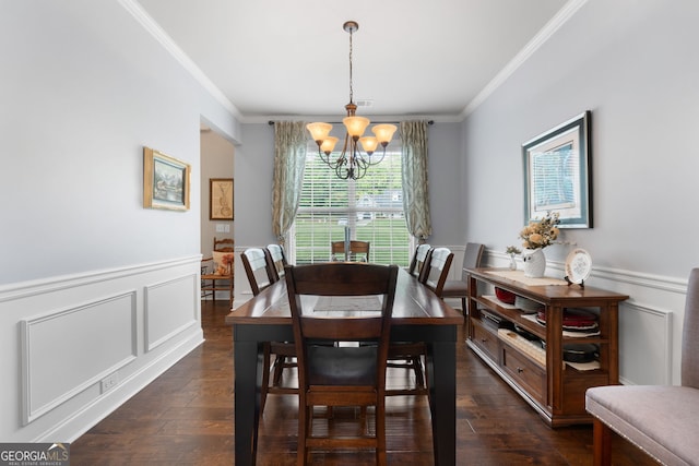 dining space featuring a chandelier, ornamental molding, dark wood finished floors, wainscoting, and a decorative wall