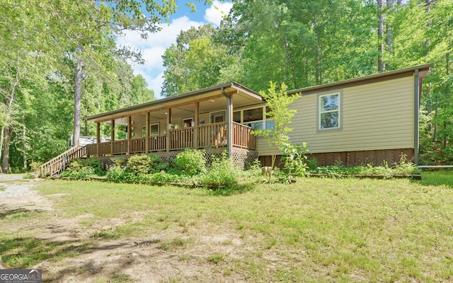 back of house with a porch and a lawn