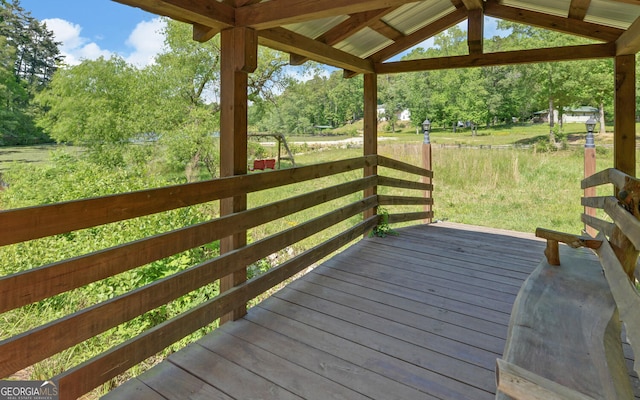 wooden deck with view of scattered trees