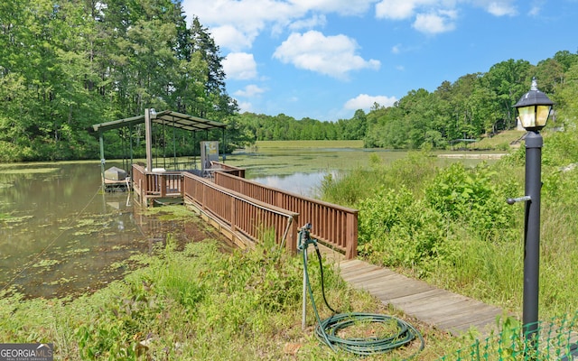 dock area featuring a water view and a forest view
