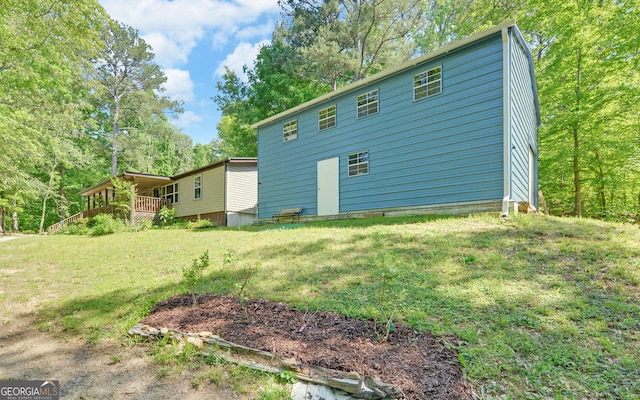 back of house with a yard and a deck