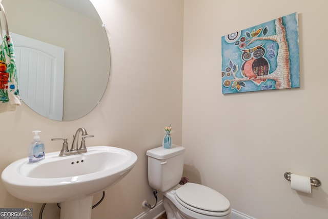 7155 Pine Seed Dr, Midland, GA 31820 - half bathroom featuring baseboards, toilet, and a sink
