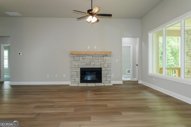 214 Wet Wood Ct Unit 26, Fairburn, GA 30213 - unfurnished living room with ceiling fan, wood finished floors, baseboards, a fireplace, and lofted ceiling
