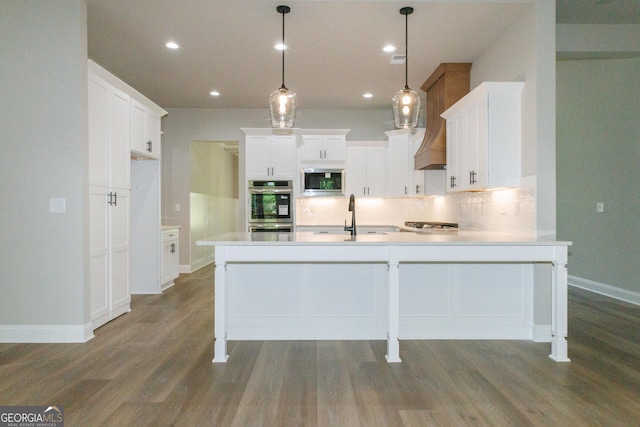 214 Wet Wood Ct Unit 26, Fairburn, GA 30213 - kitchen featuring appliances with stainless steel finishes, a peninsula, backsplash, dark wood finished floors, and recessed lighting