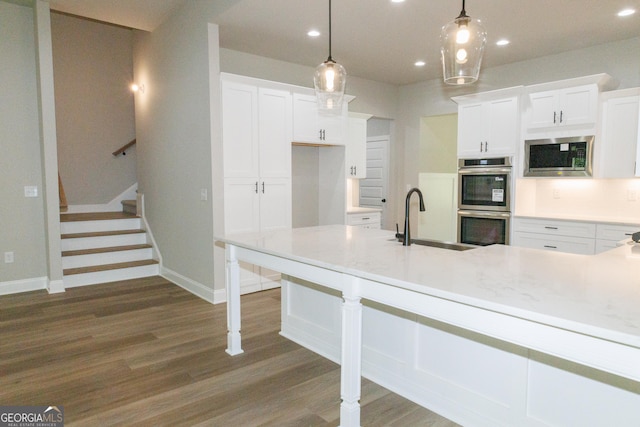 214 Wet Wood Ct Unit 26, Fairburn, GA 30213 - kitchen with a sink, appliances with stainless steel finishes, dark wood finished floors, recessed lighting, and white cabinets