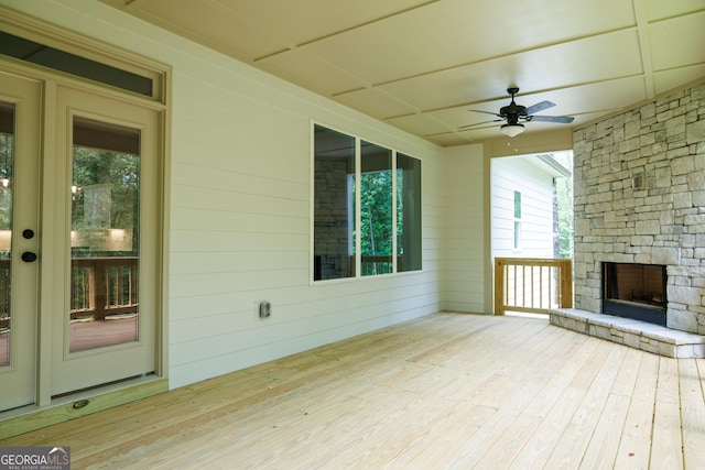 214 Wet Wood Ct Unit 26, Fairburn, GA 30213 - wooden terrace with an outdoor stone fireplace, a ceiling fan, and french doors