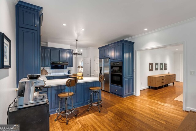 130 River Lndg NE, Sandy Springs, GA 30350 - kitchen with stainless steel refrigerator with ice dispenser, blue cabinetry, light wood-type flooring, a peninsula, and light countertops