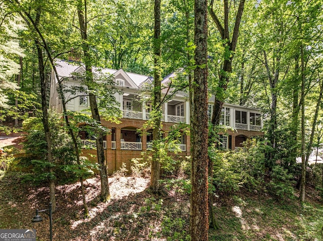 130 River Lndg NE, Sandy Springs, GA 30350 - view of front of home with brick siding, a sunroom, and a porch
