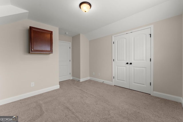 4633 Hidden Creek Dr, Gainesville, GA 30504 - unfurnished bedroom featuring vaulted ceiling, carpet, baseboards, and a closet