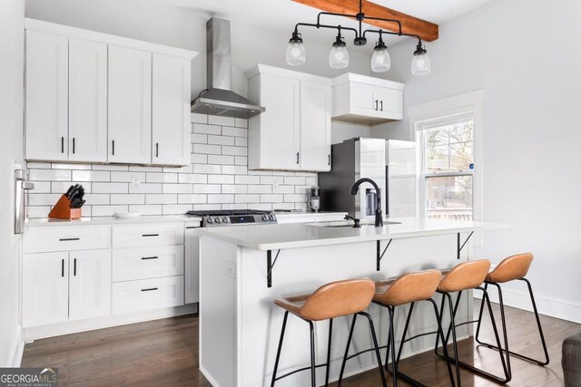 569 Hope St SW, Atlanta, GA 30310 - kitchen with wall chimney range hood, stainless steel fridge with ice dispenser, a kitchen island with sink, backsplash, and light countertops