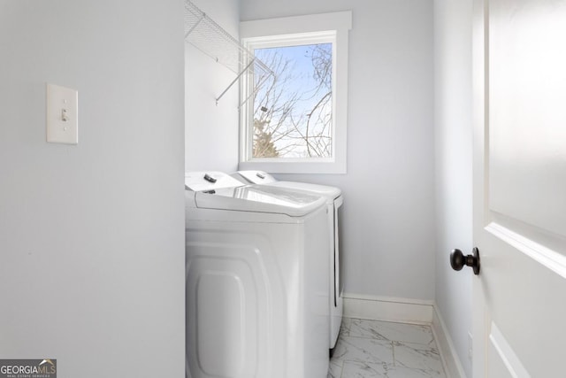 569 Hope St SW, Atlanta, GA 30310 - laundry room featuring washing machine and clothes dryer, light marble finish flooring, and baseboards