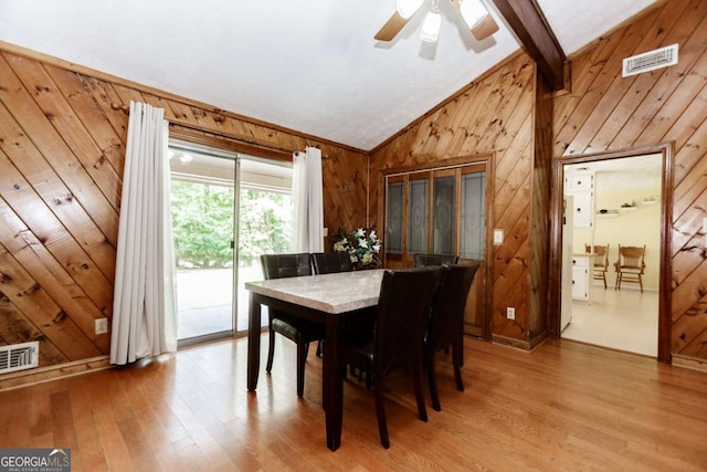 2228 Walker Dr, Lawrenceville, GA 30043 - dining space featuring wooden walls, vaulted ceiling, light wood finished floors, and ceiling fan