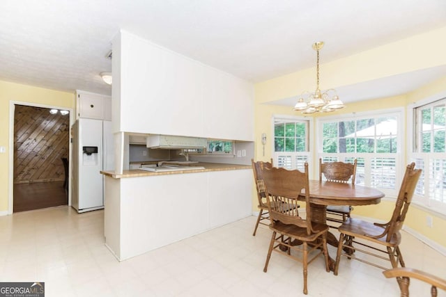 2228 Walker Dr, Lawrenceville, GA 30043 - dining space featuring a chandelier and light floors