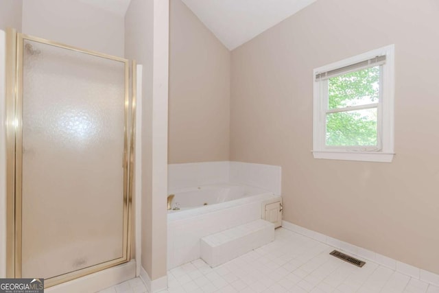 2228 Walker Dr, Lawrenceville, GA 30043 - full bath with a whirlpool tub, a stall shower, lofted ceiling, baseboards, and tile patterned flooring